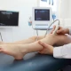 Ultrasound probe on a patient's leg with screen display.